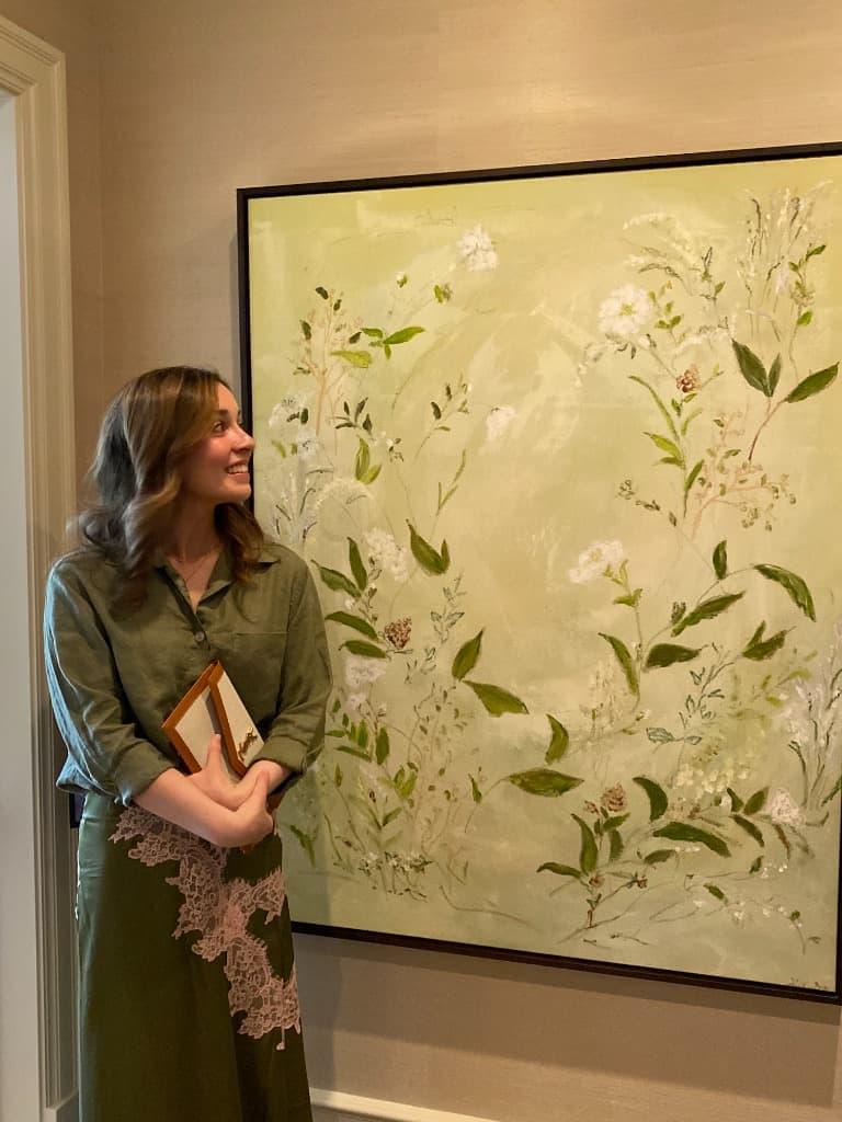 Grace beside her large green botanical painting at the Studio McGee Showcase Home