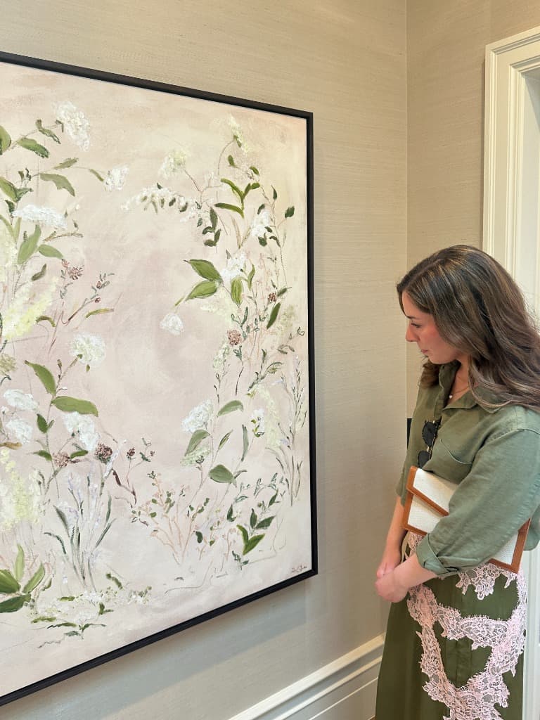 Detail of the blush floral painting in its black frame