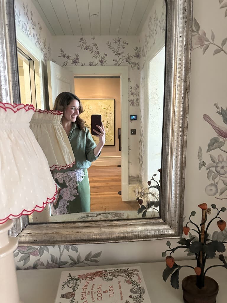 A mirror view inside the Showcase Home with the green painting visible beyond